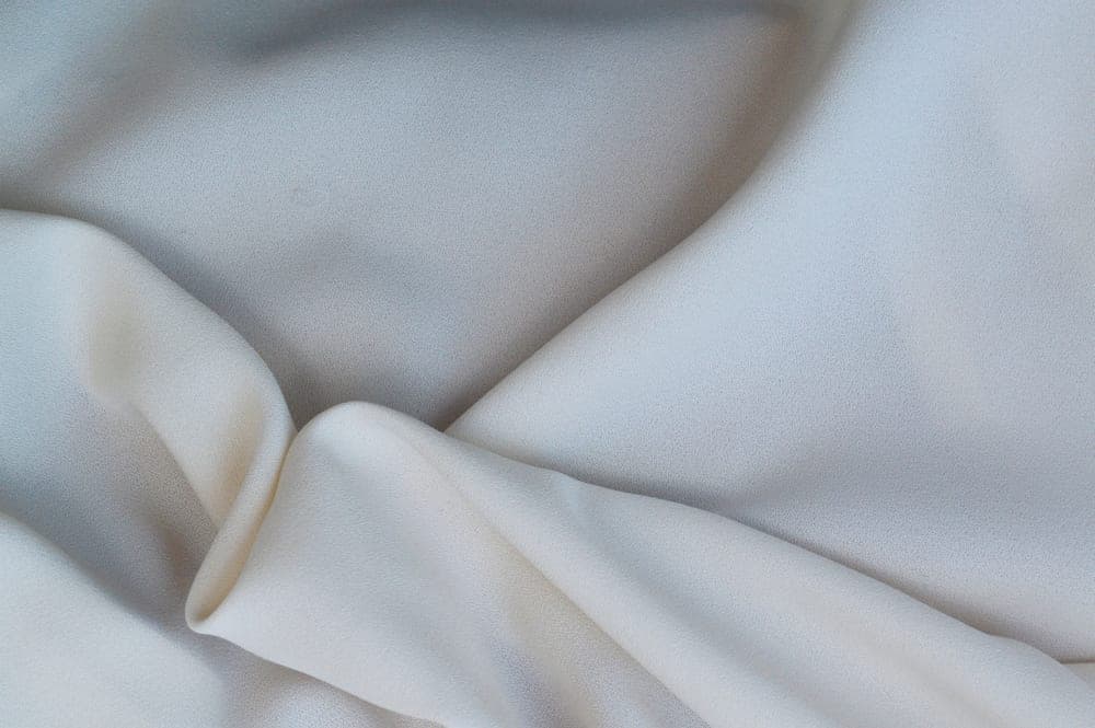 Folds of smooth pale silk photographed close up - illustrative category image