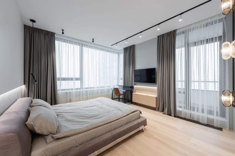 Bedroom with curtains drawn against bright daylight