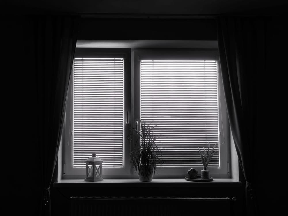 Heavy blackout curtains drawn across a bedroom window