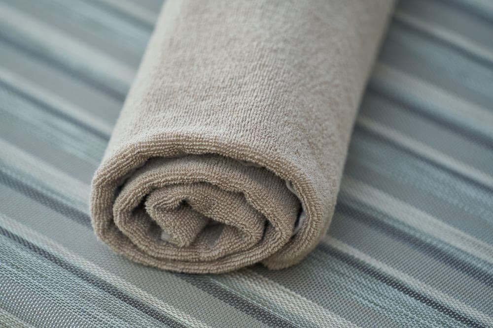 Weighted eye pillow resting on a folded towel