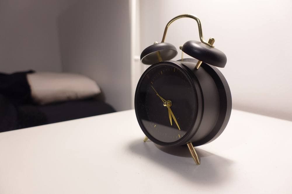 Simple alarm clock on a minimalist bedside table