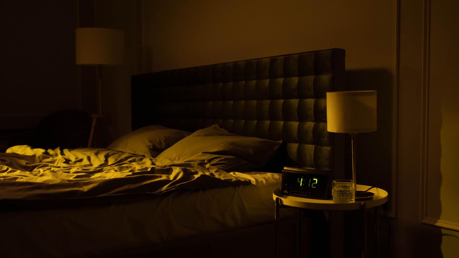 Small speaker on a nightstand in a dim bedroom at night