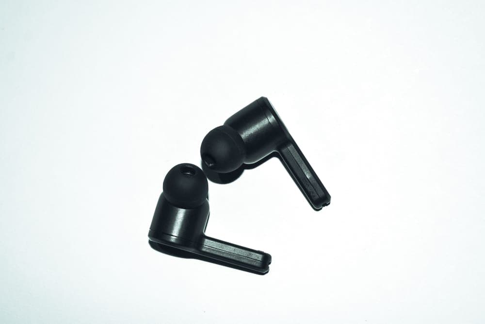 Pair of small in-ear devices on a white background - illustrative category image
