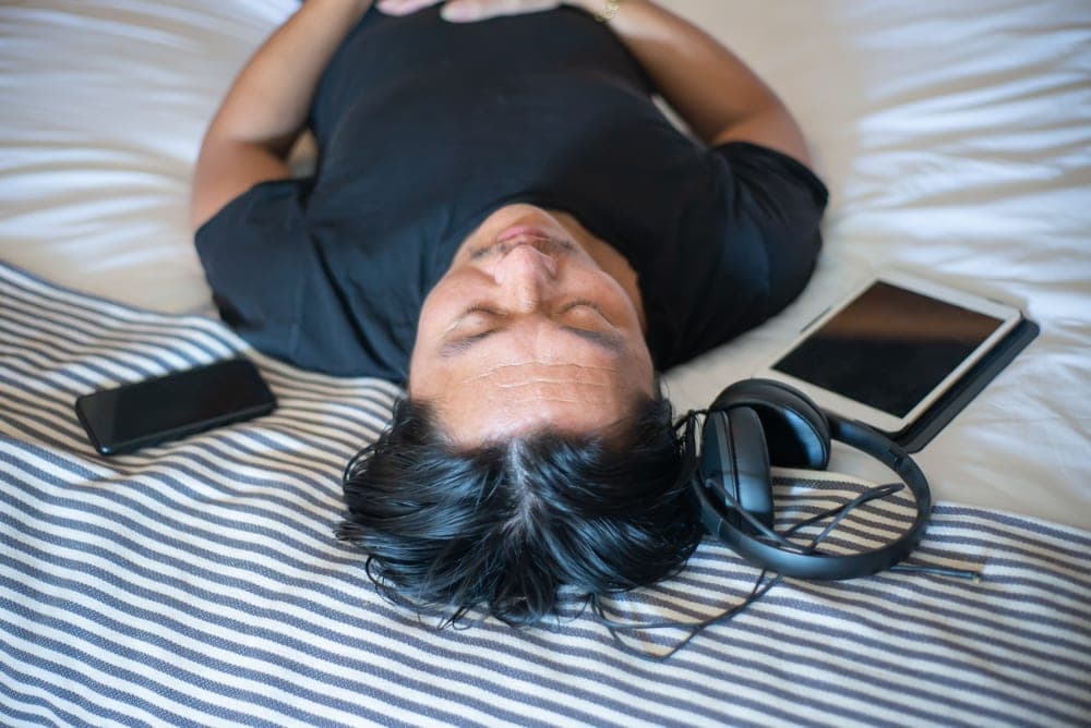 Person lying down wearing headphones - illustrative category image