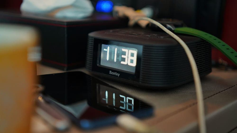 Illuminated bedside clock display at night - illustrative category image
