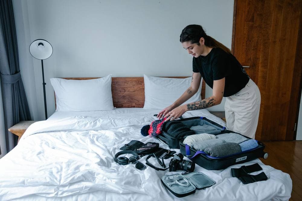 Open suitcase being packed on a bed - illustrative category image