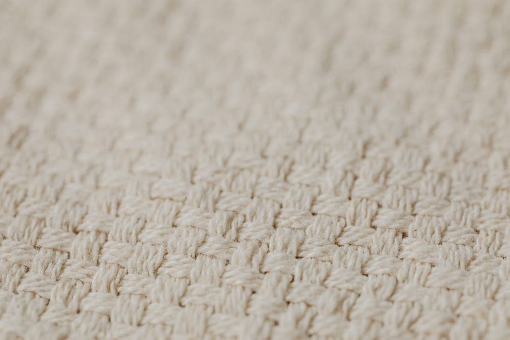 Open-weave textile photographed close up, showing gaps between the threads - illustrative category image