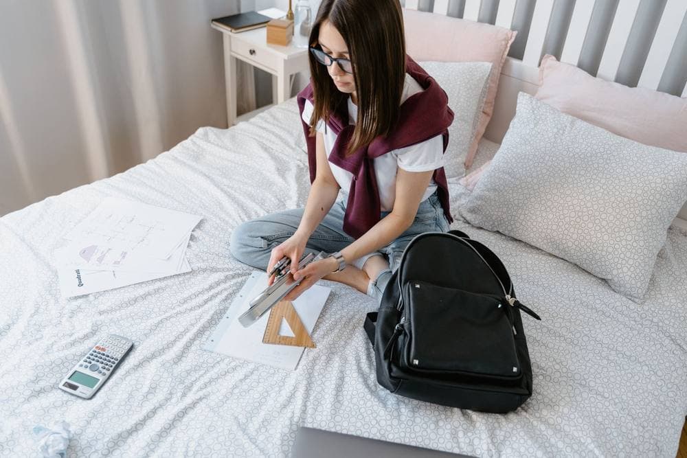 Teenager's bedroom with a made bed and a study desk
